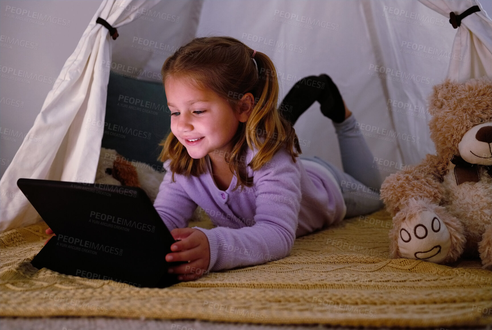 Buy stock photo Tablet, tent and kid in home playing educational games or online activities for cognitive development. Relax, blanket fort and girl child watch movie on streaming app with digital technology in house