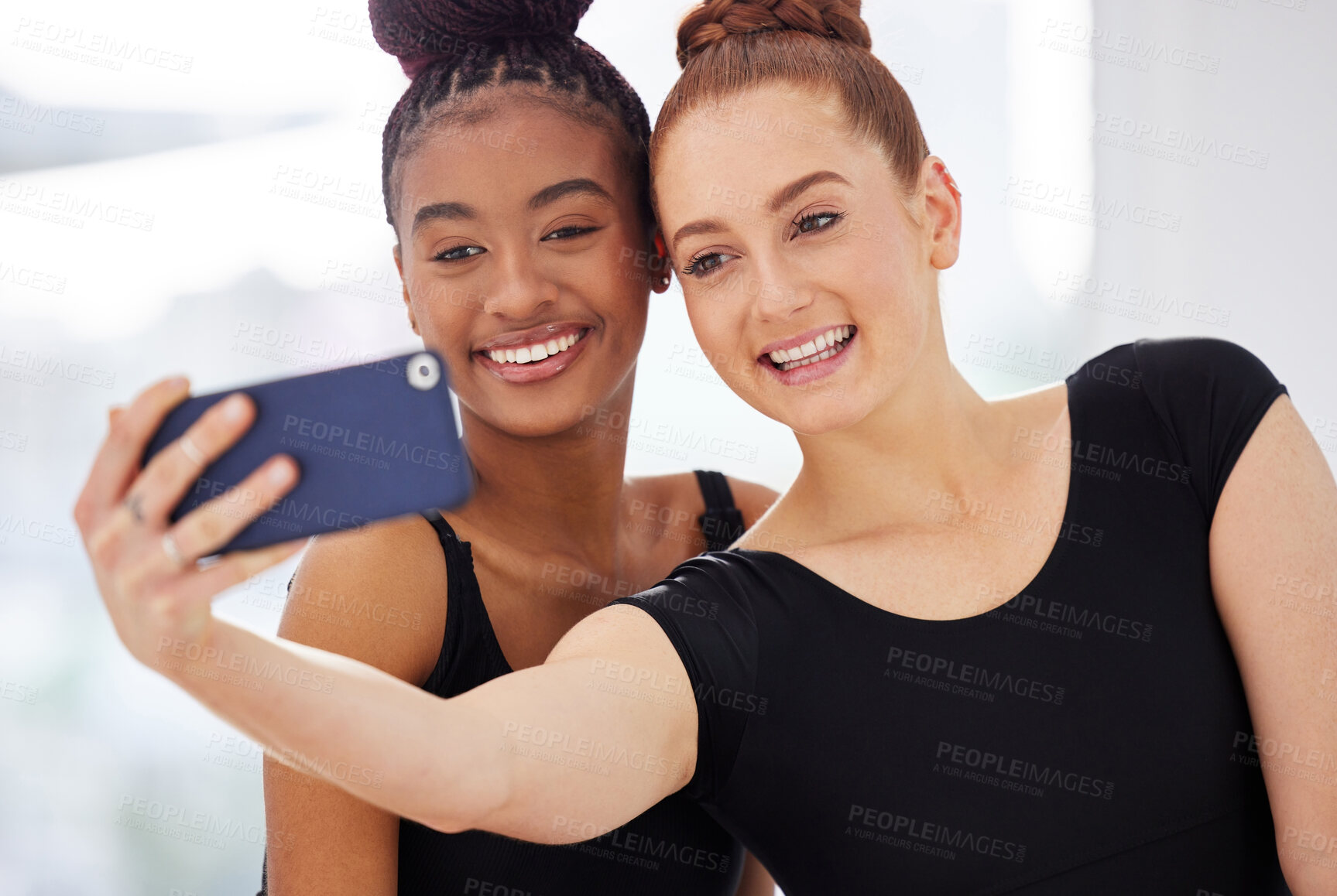 Buy stock photo Shot of two ballerinas taking selfies using a smartphone