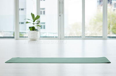 Buy stock photo Shot of a mat in an empty yoga studio during the day