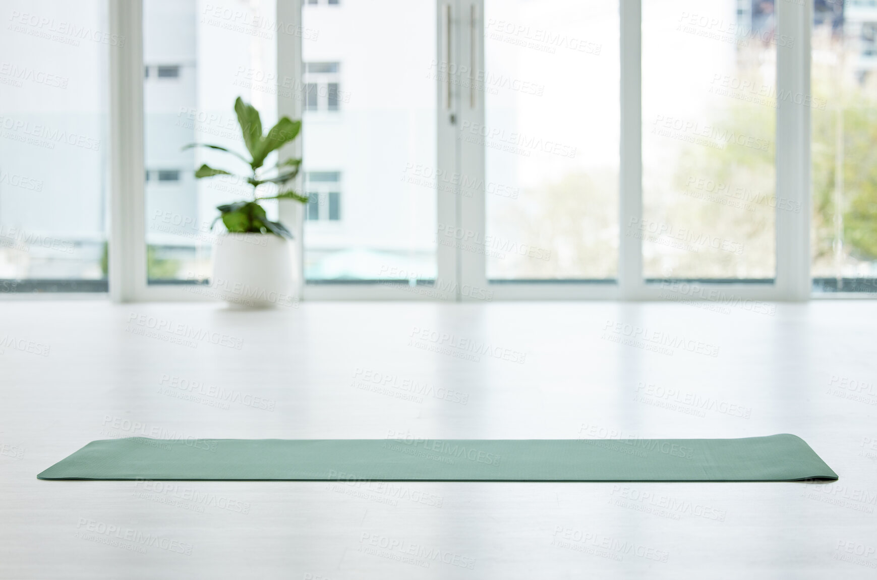 Buy stock photo Shot of a mat in an empty yoga studio during the day