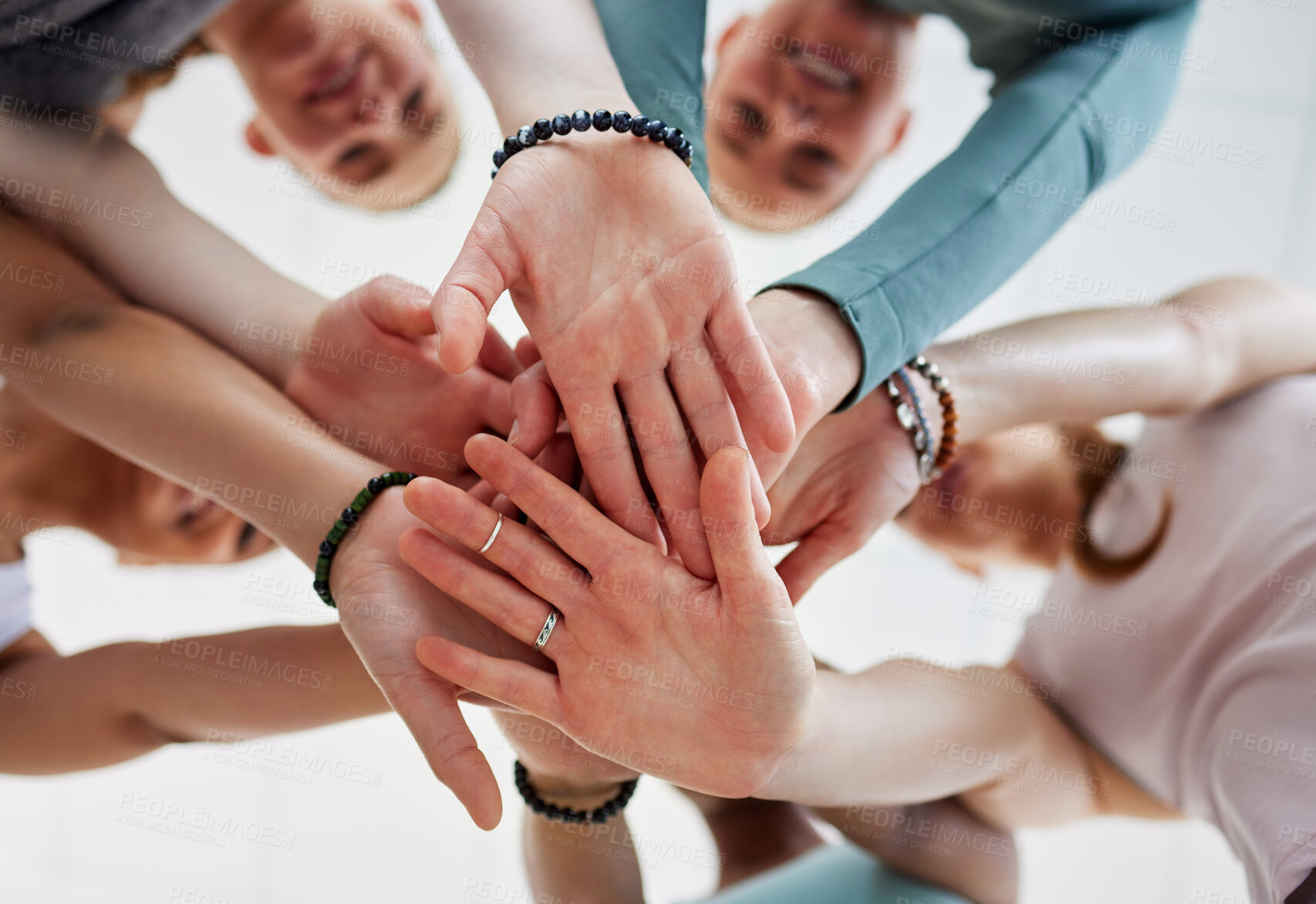 Buy stock photo Low angle shot of an unrecognisable group of women huddled with their hands stacked in the middle after yoga