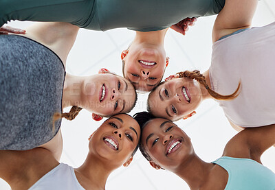 Buy stock photo Low angle shot of a diverse group of women huddled together after practising yoga