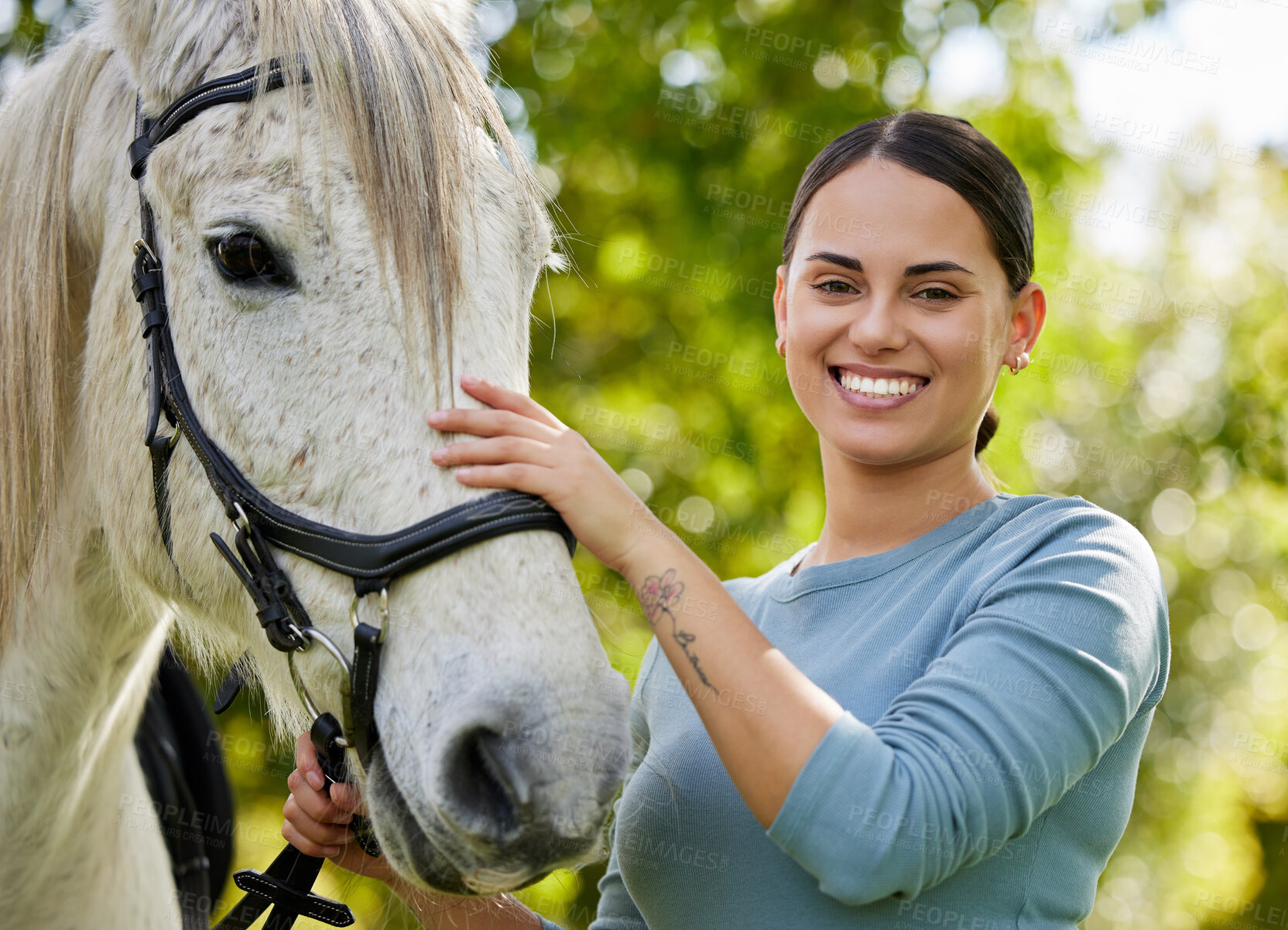 Buy stock photo Shot of an attractive young woman standing with her horse in a forest