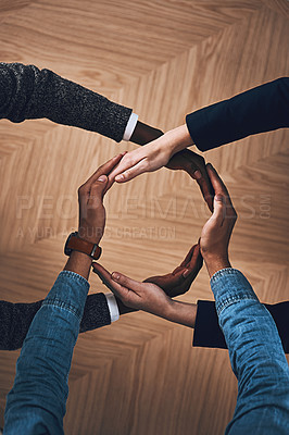 Buy stock photo High angle shot of a group of unidentifiable businesspeople forming a circle with their hands