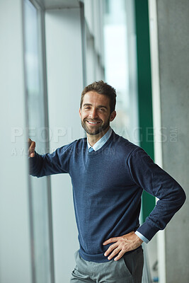 Buy stock photo Cropped portrait of a handsome young businessman standing indoors alone during the day