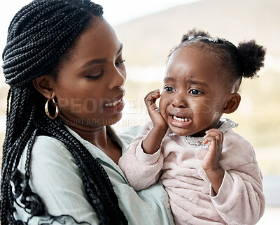Buy stock photo Shot of a woman holding her upset daughter