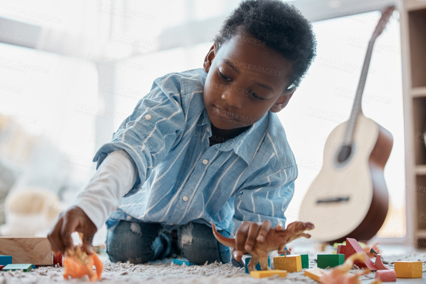 Buy stock photo Shot of an adorable little boy playing with his toys in his bedroom