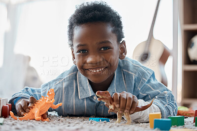 Buy stock photo Shot of an adorable little boy playing with his toys in his bedroom
