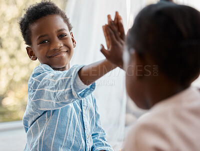 Buy stock photo Shot of a little boy and his sister sharing a high five