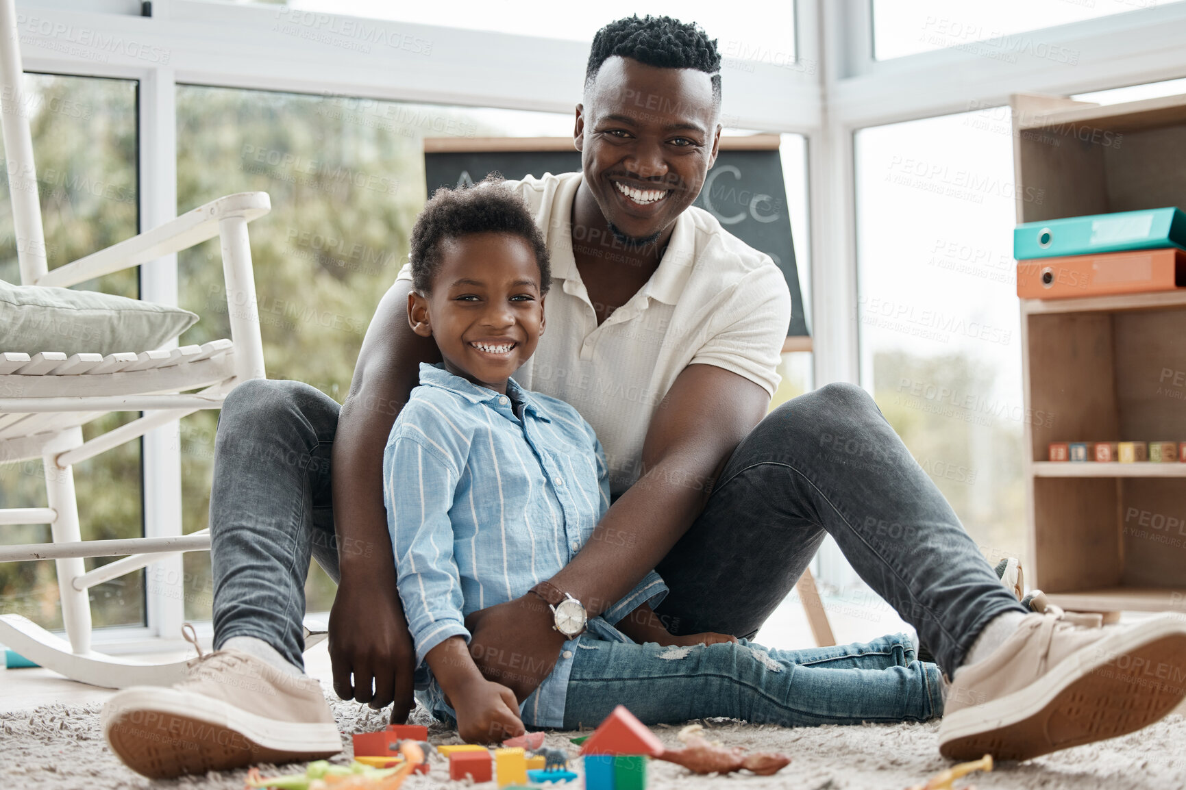 Buy stock photo Father, child and smile in portrait with toys together in home for learning, entertainment or bonding in living room. Black family, dad and boy in house for kids games, babysitting and development