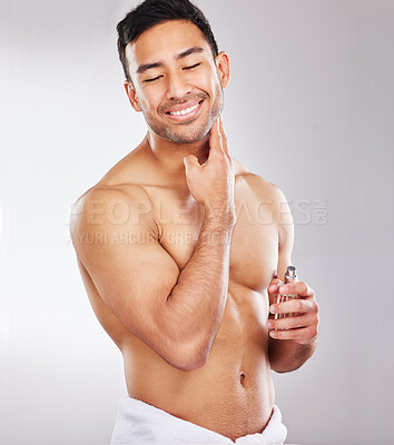 Buy stock photo Studio shot of a handsome young man applying aftershave