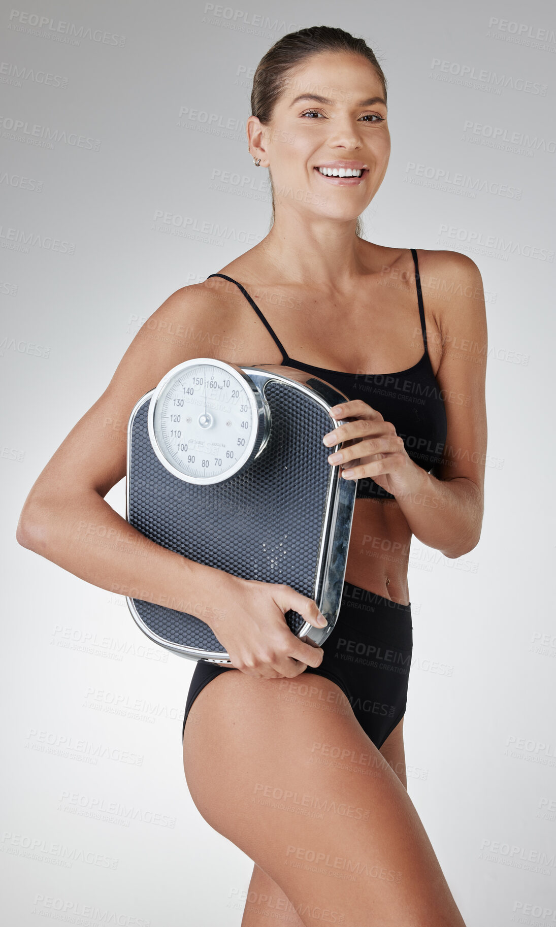 Buy stock photo Smile, scale and woman with underwear in studio for fitness progress, confidence and wellness. Body, benefits and girl in sportswear for self care, weight loss and diet results on white background.