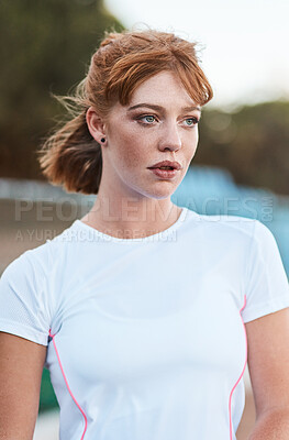 Buy stock photo Shot of an attractive young woman standing alone outside after playing hockey