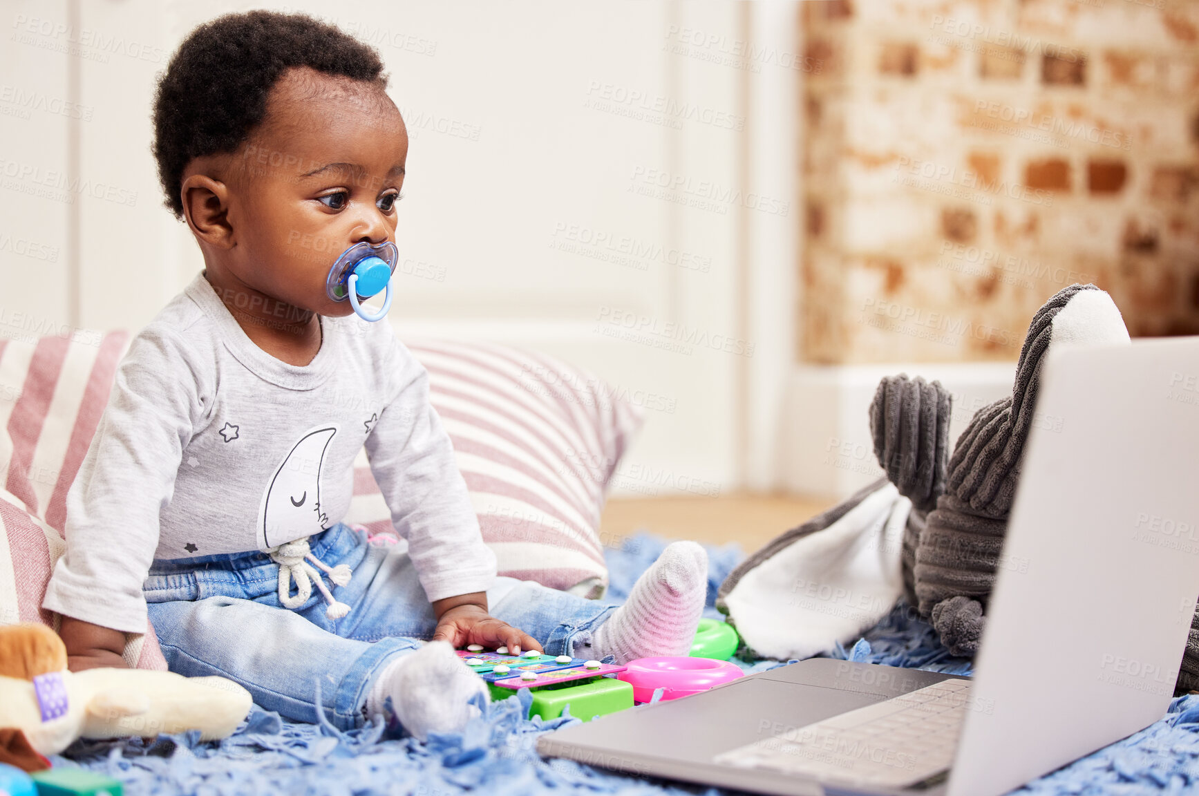 Buy stock photo Shot of a little baby watching her favourite program on a laptop