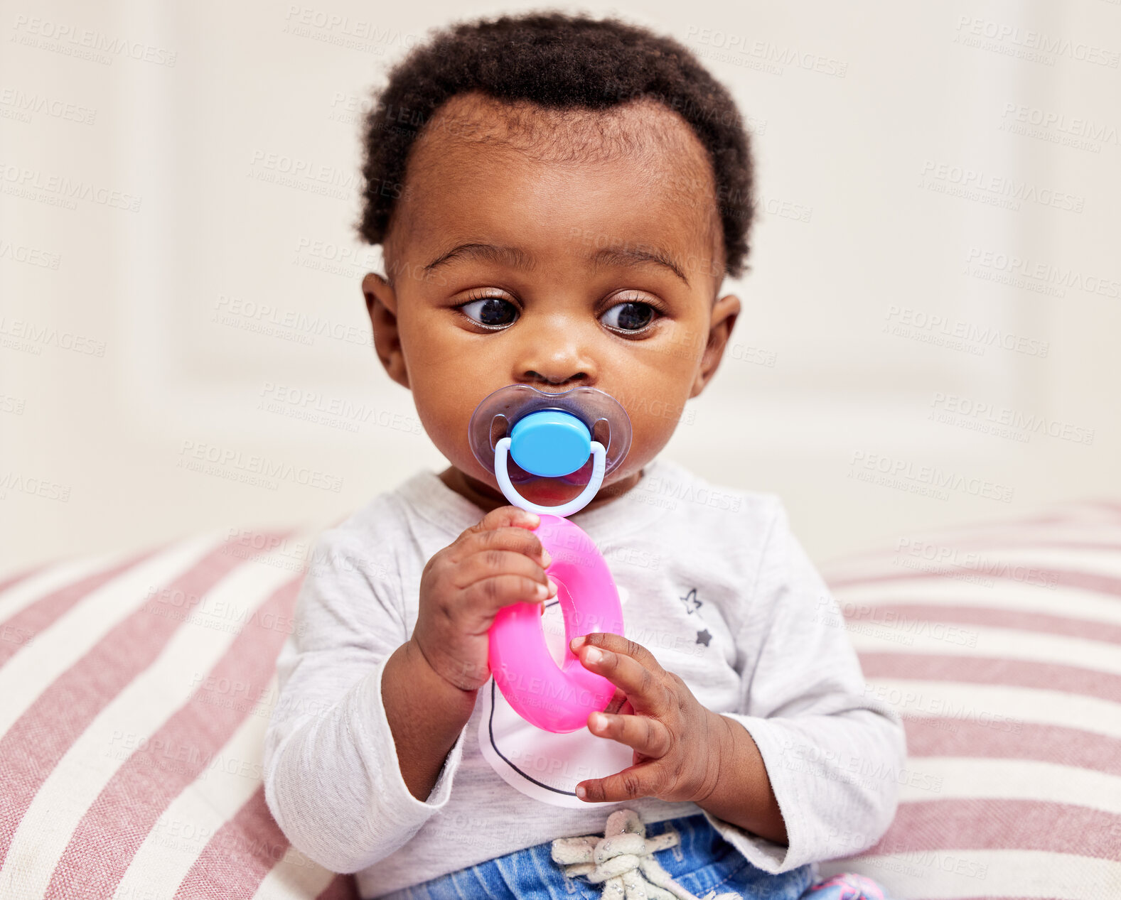 Buy stock photo Black baby, playing and toy with pacifier on bed for entertainment, comfort or childhood at home. Young African or little child, cute toddler or adorable infant with dummy or teether in bedroom