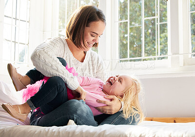 Buy stock photo Shot of a young mother and daughter spending time together at home