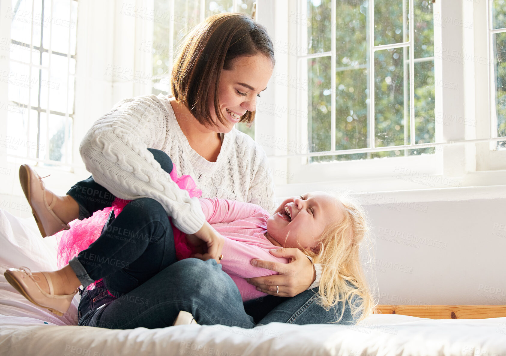 Buy stock photo Shot of a young mother and daughter spending time together at home