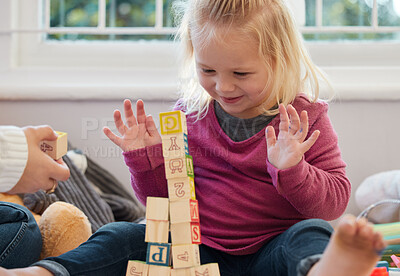 Buy stock photo Shot of a little girl stacking blocks with her mother at home