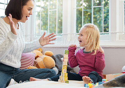 Buy stock photo Shot of a little girl stacking blocks with her mother at home