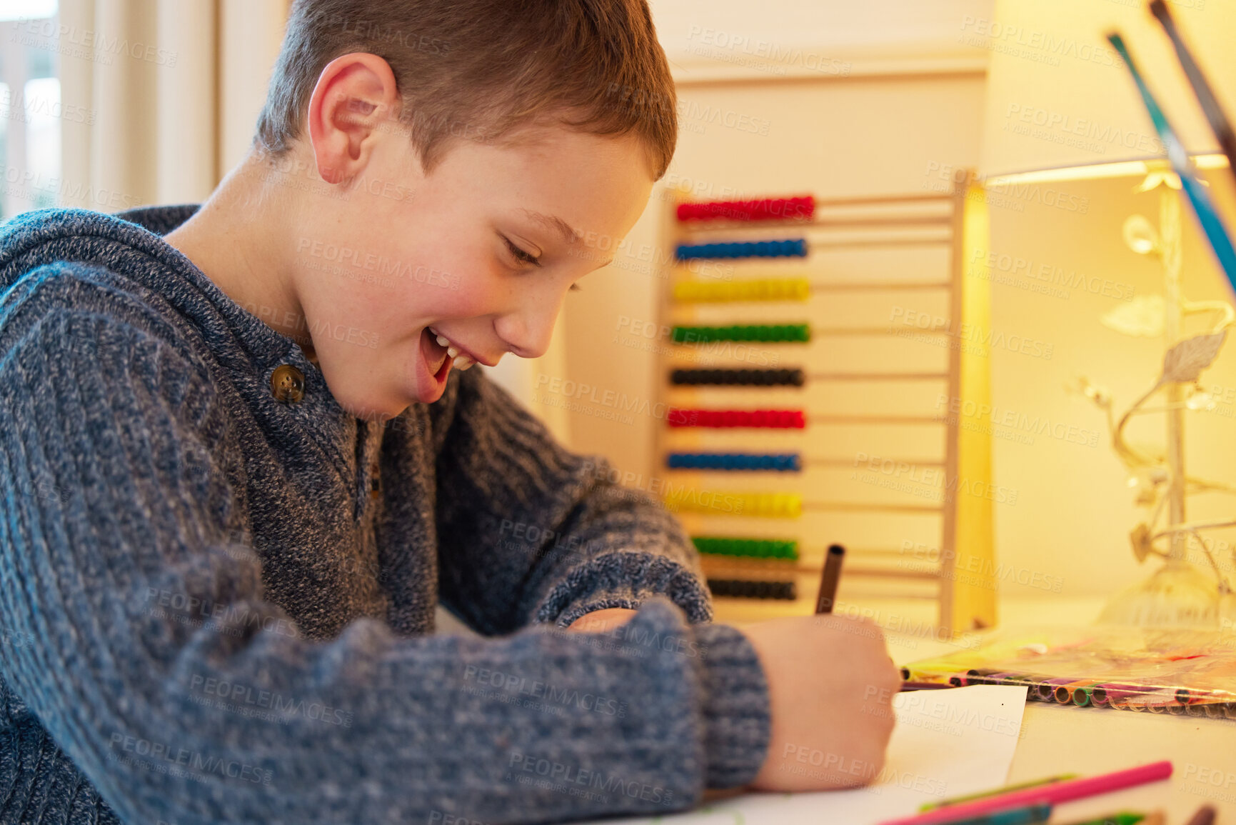 Buy stock photo Shot of a young boy completing his homework