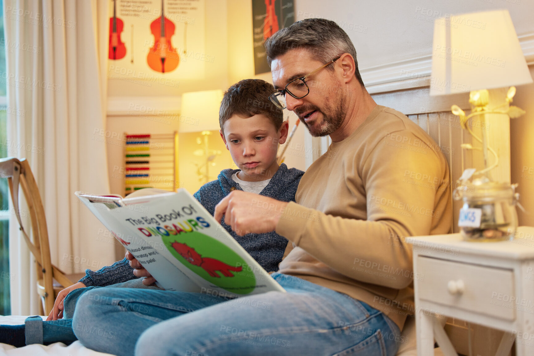 Buy stock photo Bedroom, reading and dad with child with books in bed for learning, education and language development. Relax, home and father with boy with bedtime story for fantasy, literacy hobby and bonding