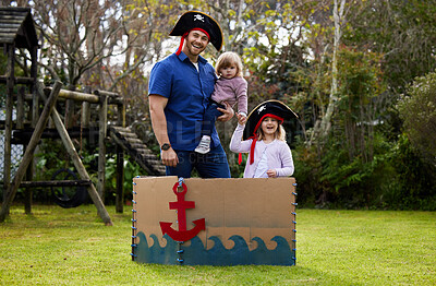 Buy stock photo Shot of a father and daughters dressed up like pirates outside in the yard