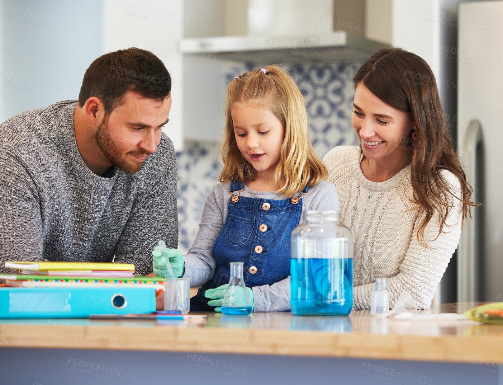 Buy stock photo Shot of a family completing science experiments at home
