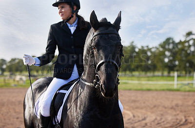 Buy stock photo Cropped shot an attractive young female jockey riding her horse out on the farm