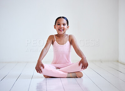 Buy stock photo Portrait of a little girl sitting with her legs crossed in a ballet studio