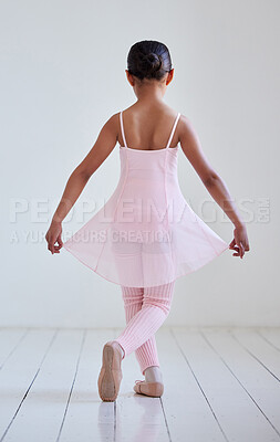 Buy stock photo Rearview shot of a little girl practicing ballet in a dance studio