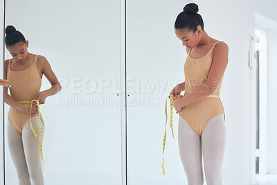Buy stock photo Shot of a beautiful young ballet dancer measuring her waist during a rehearsal