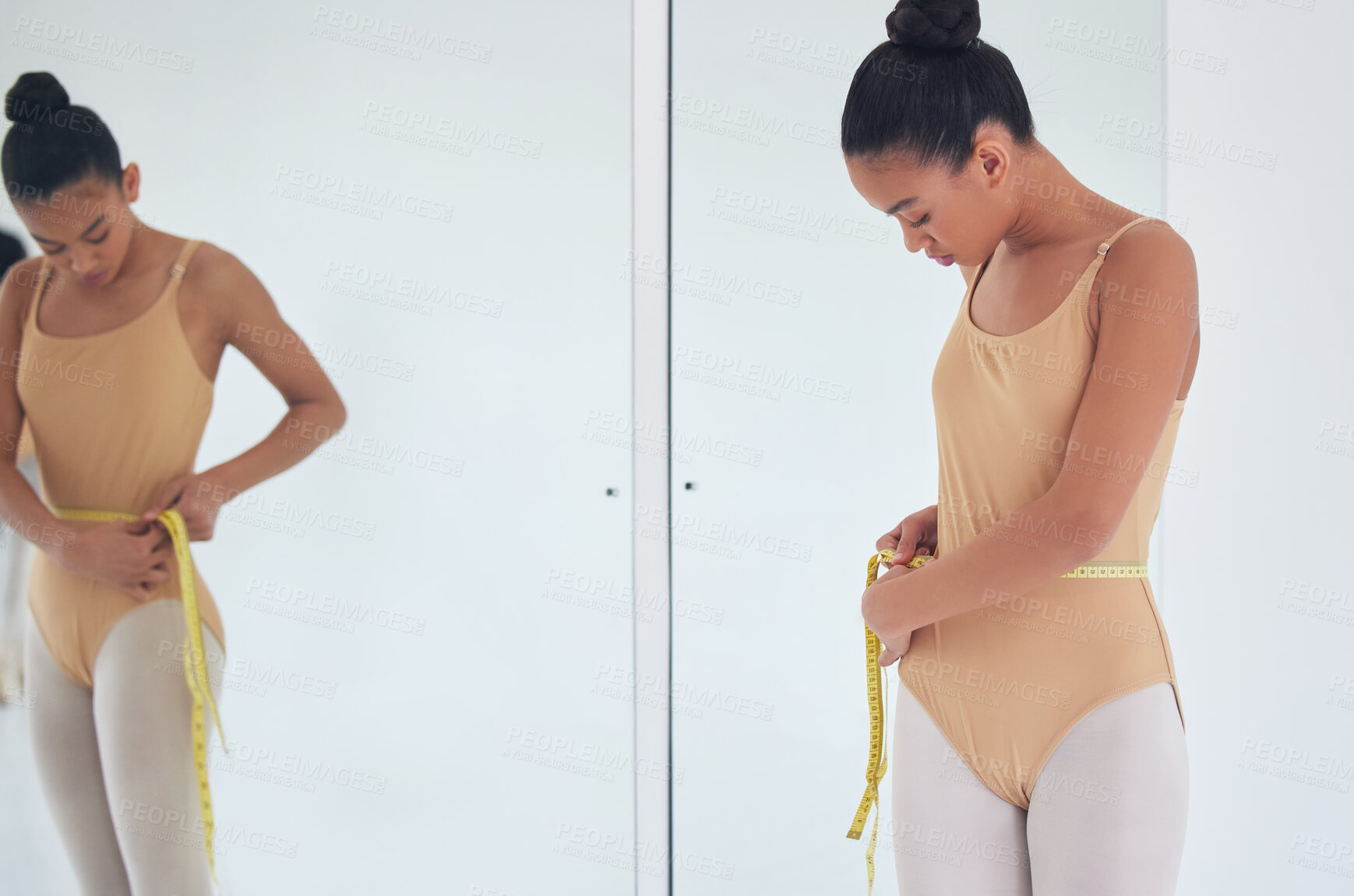 Buy stock photo Shot of a beautiful young ballet dancer measuring her waist during a rehearsal