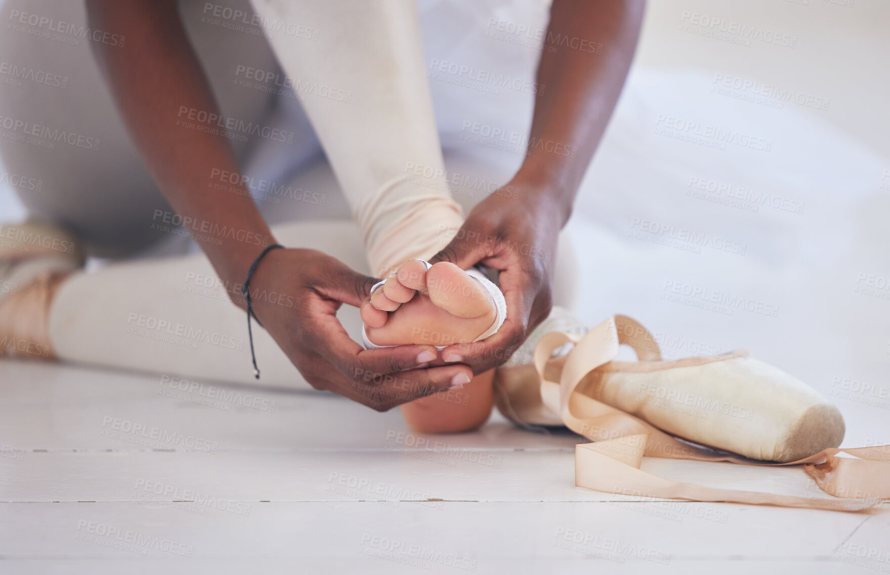 Buy stock photo Ballet, hands and foot of ballerina with bandage, comfort and support for inflammation with training. Creative studio, person and wrap on floor for injury prevention, blister or calluses for practice