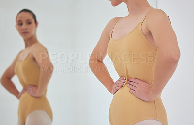 Buy stock photo Shot of a young ballet dancer inspecting her figure in a mirror during a rehearsal