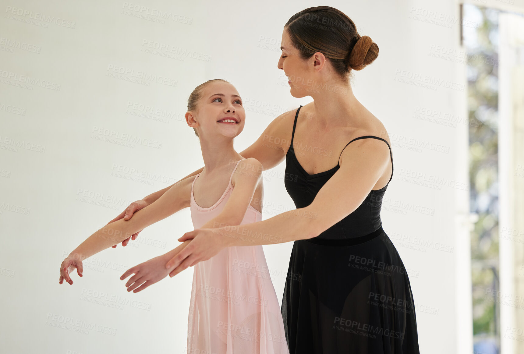 Buy stock photo Shot of a young girl practicing ballet with her teacher in a dance studio