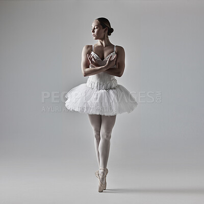 Buy stock photo Full of a beautiful young ballet dancer rehearsing in a dance studio