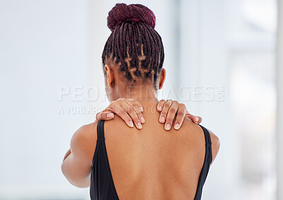 Buy stock photo Shot of a young ballerina suffering from shoulder pain