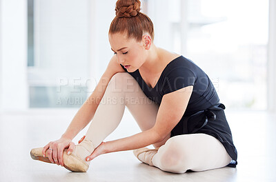 Buy stock photo Cropped shot of a ballerina experiencing discomfort in her foot