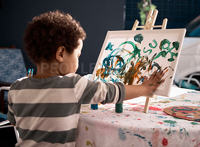 Buy stock photo Shot of a little boy painting on a canvas