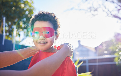 Buy stock photo Shot of an adorable little boy wearing a superhero costume while playing outdoors