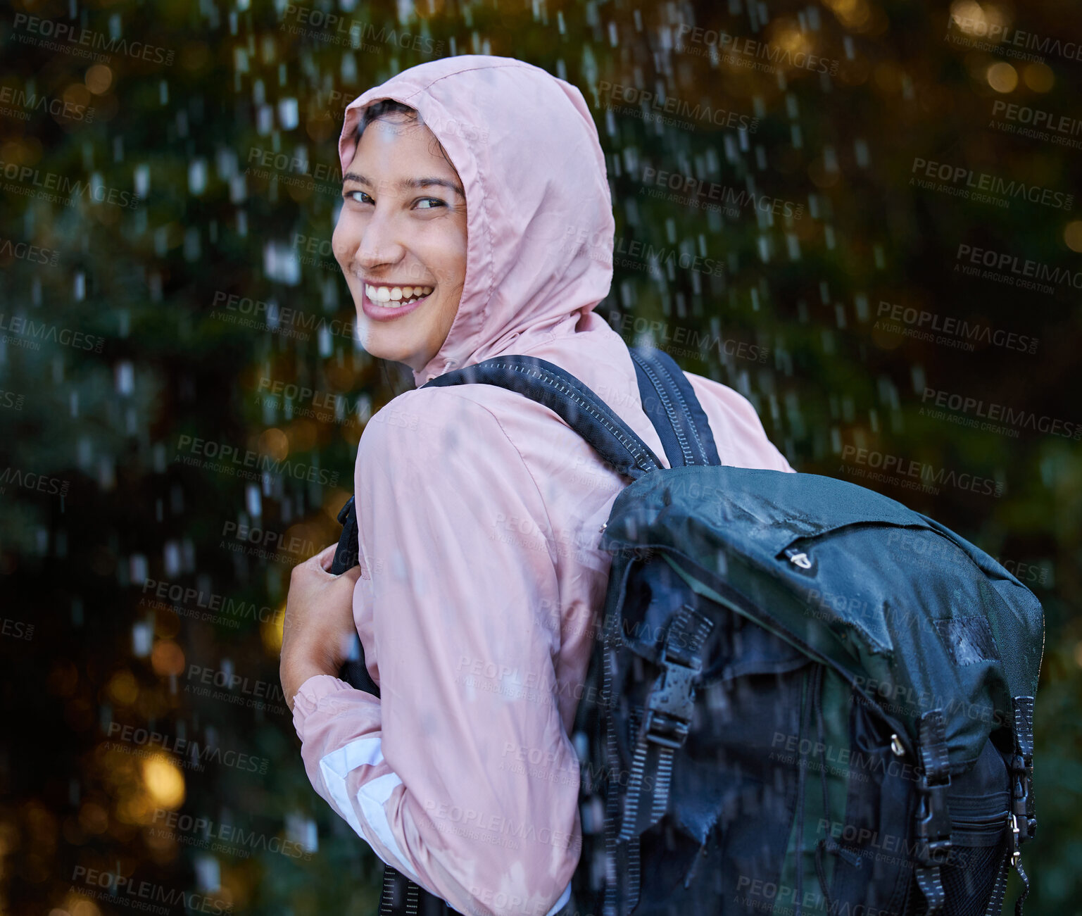 Buy stock photo Shot of an attractive young woman standing alone outside in the rain