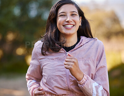 Buy stock photo Shot of an attractive young woman jogging alone outside