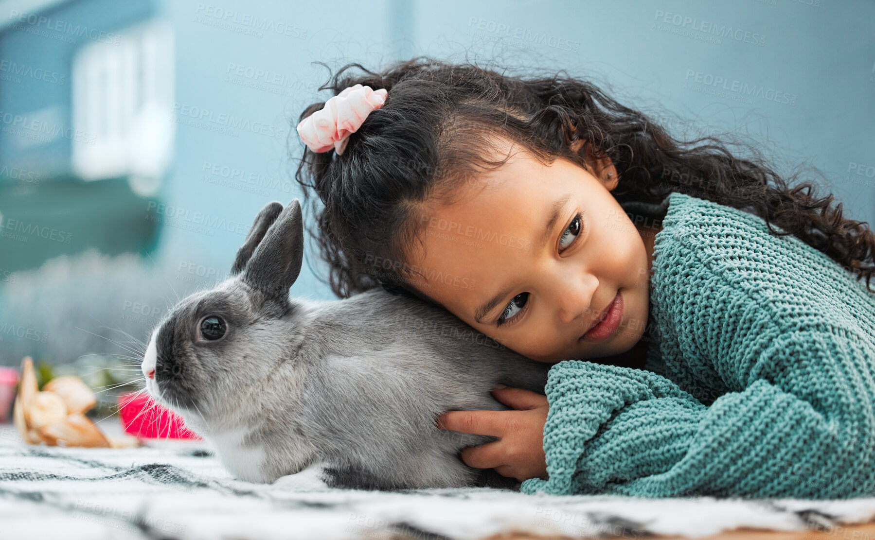 Buy stock photo Shot of an adorable little girl bonding with her pet rabbit at home