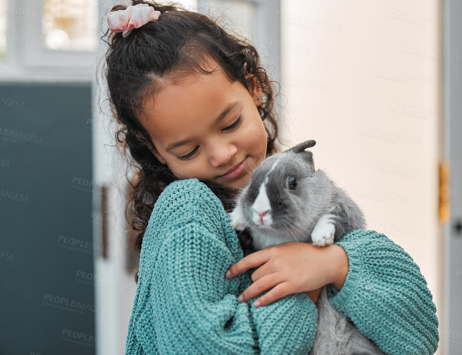 Buy stock photo Shot of an adorable little girl bonding with her pet rabbit at home