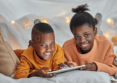 Buy stock photo Portrait of a brother and sister using a digital tablet together at home