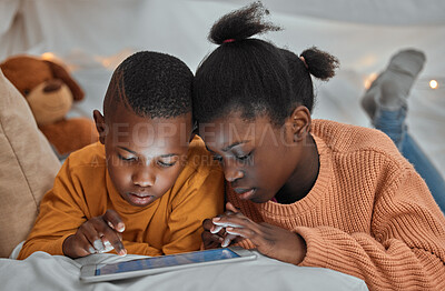 Buy stock photo Shot of a brother and sister using a digital tablet together at home