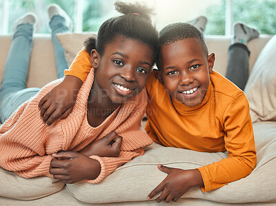 Buy stock photo Portrait of a brother and sister relaxing together on a sofa at home