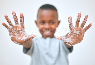 Buy stock photo Shot of a little boy showing his hands after washing them at home