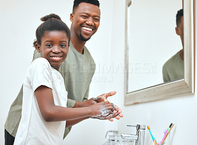Buy stock photo Shot of a young father and daughter washing their hands in a bathroom at home