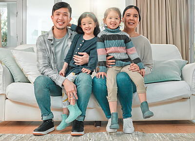 Buy stock photo Portrait of a young family bonding on the sofa at home